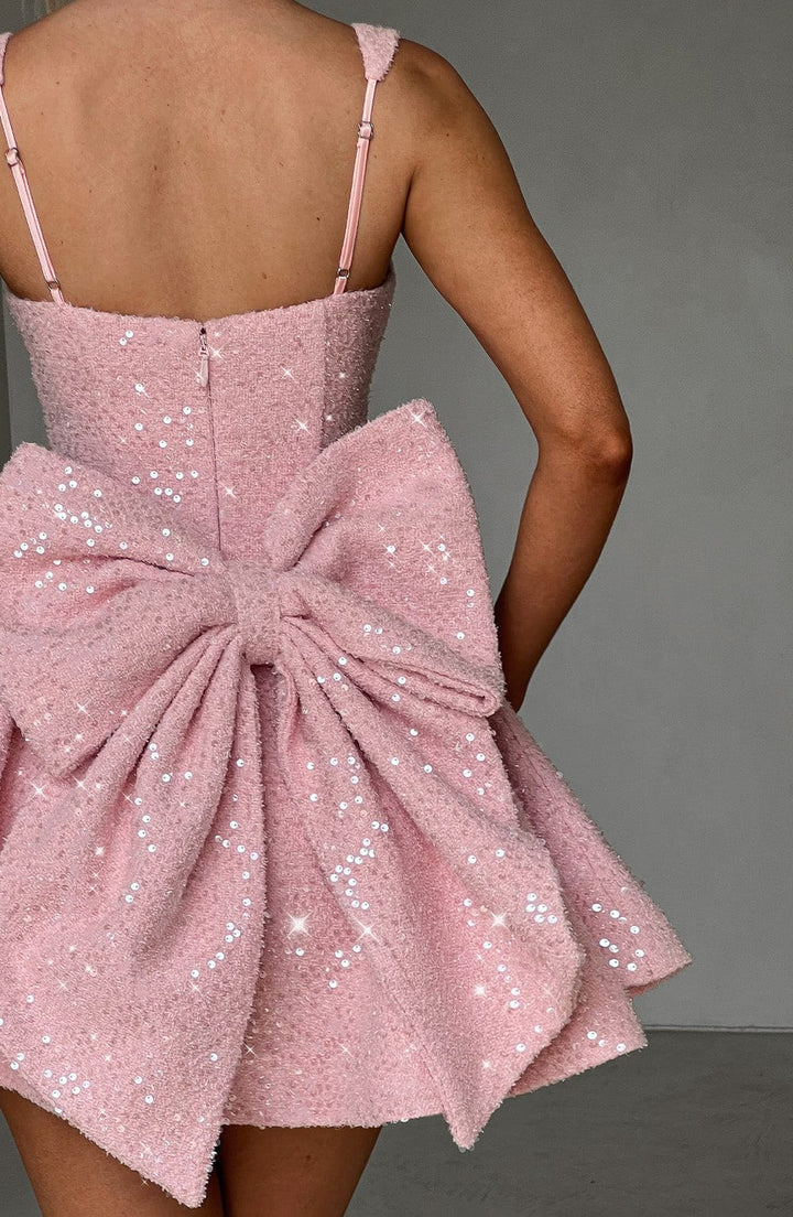 Pink sequin dance dress for women, skater style with a cute bow, suitable for special events.