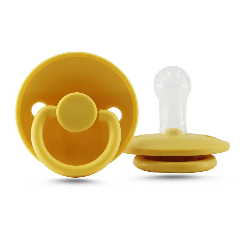 Baby gently holding a silicone soother, infant pacifier for comfort, newborn feeding time
