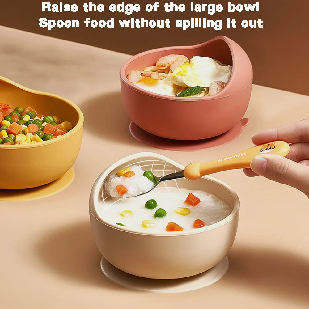 Green silicone suction bowl for secure baby feeding, preventing spills on high chair trays.