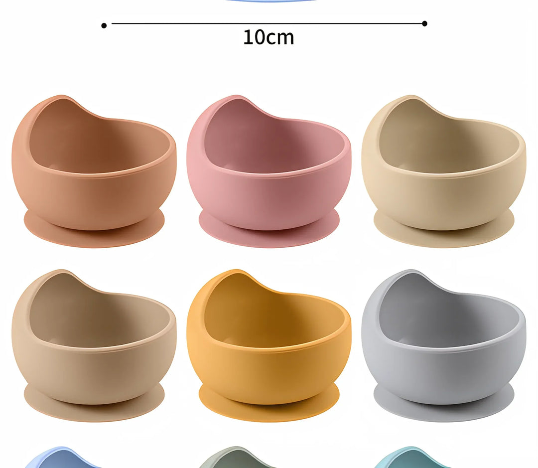 Baby's first meal in a secure, yellow silicone suction bowl, ideal for weaning.