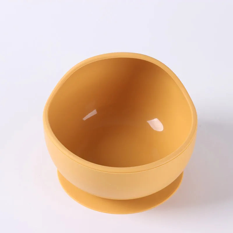 Orange silicone suction bowl with strong non-slip base, perfect for active toddlers.