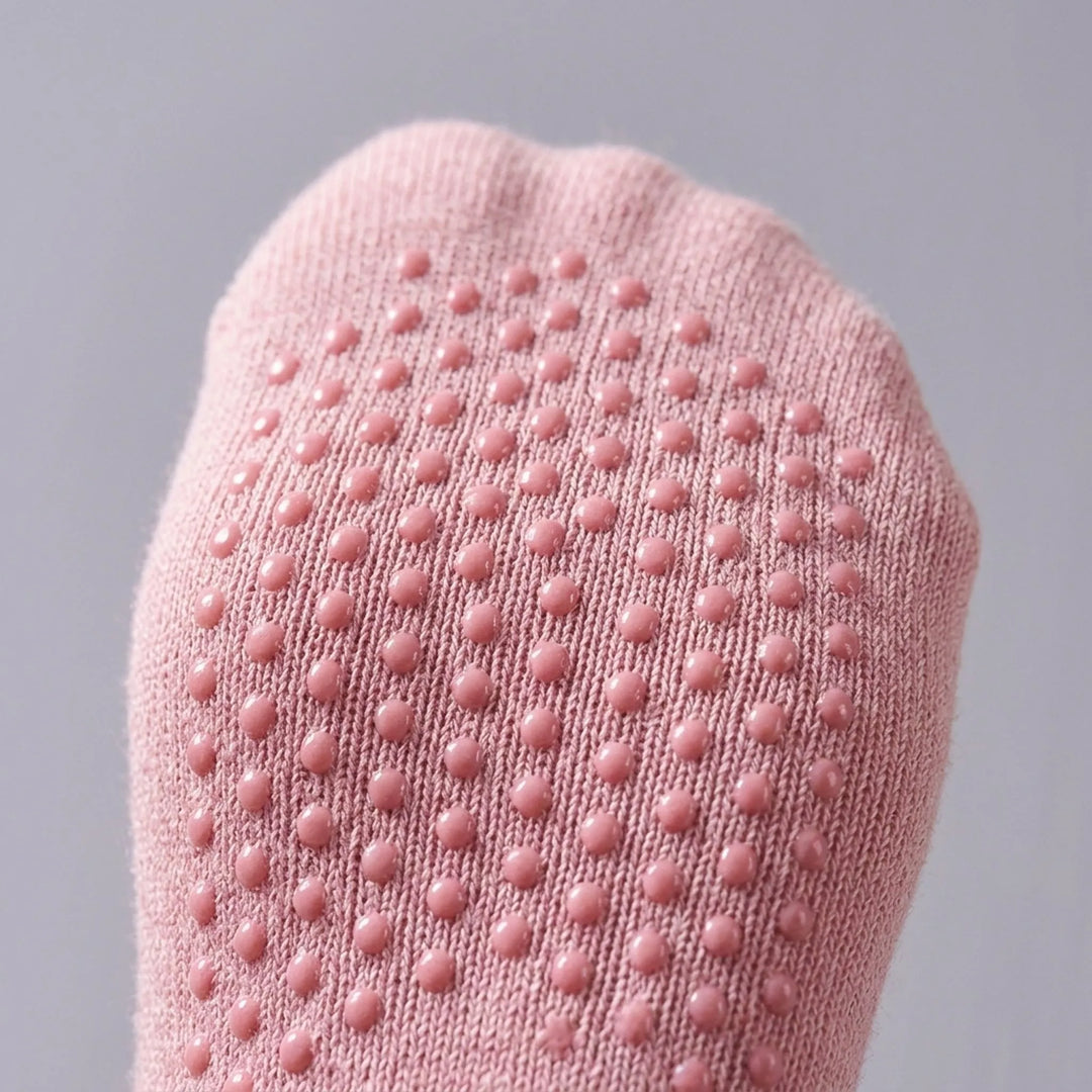 Pink women's pilates & yoga socks with non-slip grip for improved balance. Comfortable low-cut studio workout socks.