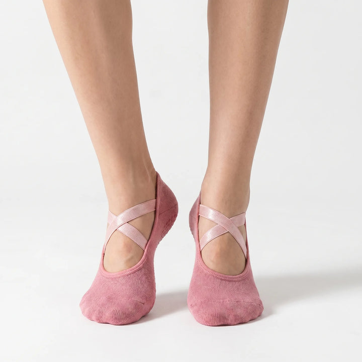 Pink women's activewear grip socks, perfect for studio yoga, pilates & barre. Non-slip low-cut athletic accessory.