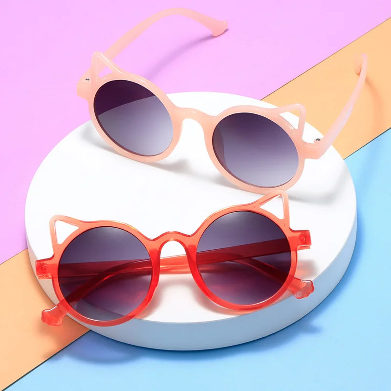 Close-up of fashionable kids cat-eye sunglasses in vibrant purple.