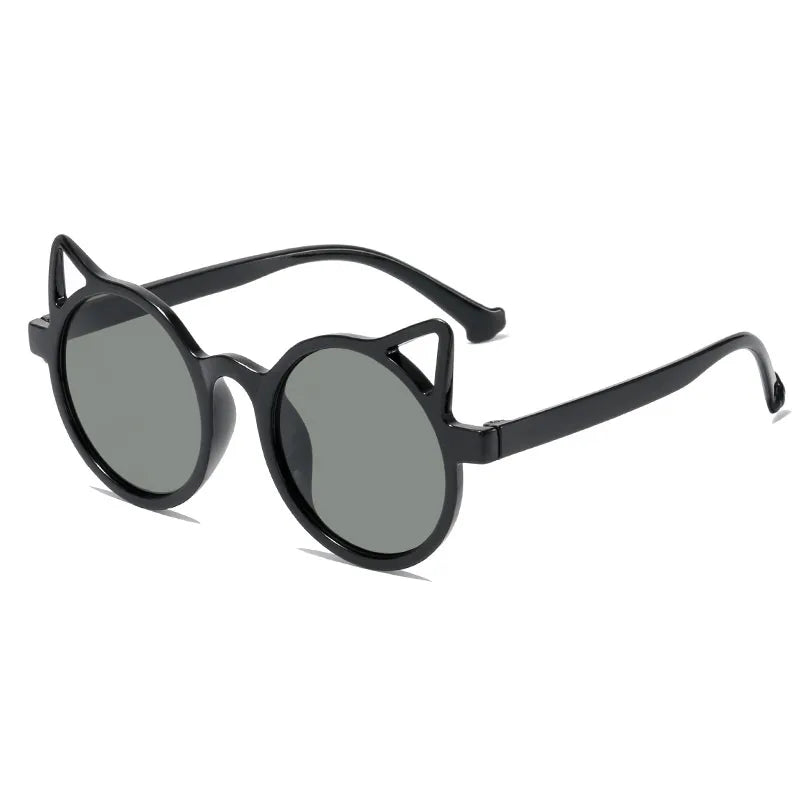 Toddler girl posing with cute cat-eye sunglasses, a fun children's fashion accessory.
