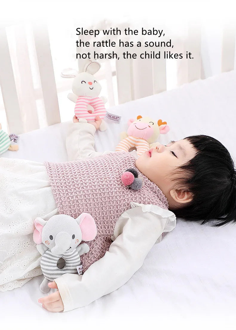Smiling cartoon dog plush baby rattle, an engaging sensory toy with a firm ring handle for babies.