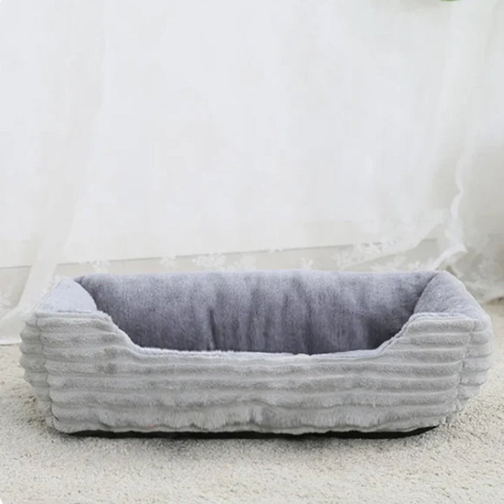Washable plush pet bed for hassle-free cleaning. Provides a hygienic and comfortable sleeping space.