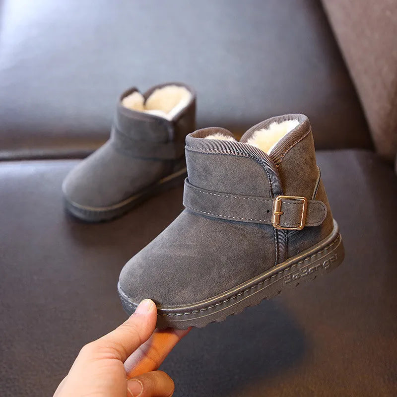 Insulated boys' snow boots with a robust cotton exterior and plush interior for cold weather.