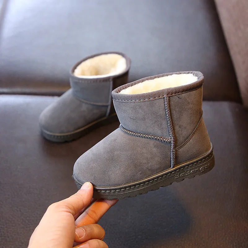 Collection of colorful kids' winter boots, showcasing various cotton and plush designs for snow.