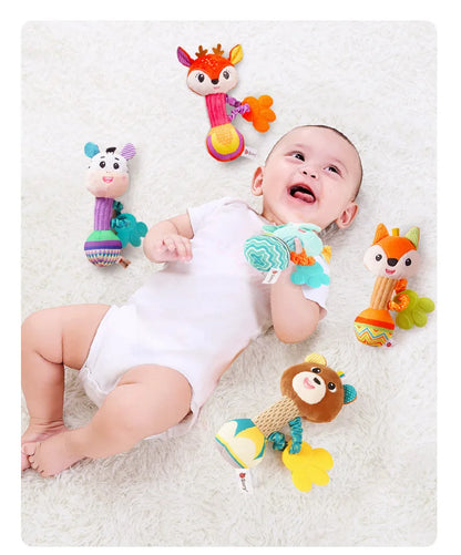 Infant grasping a plush lion rattle with crinkling sounds, developing fine motor skills and sensory awareness.