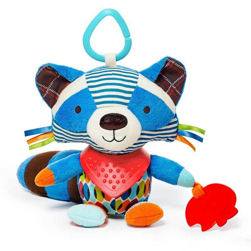 Baby's hand holding a plush monkey sensory rattle toy with a teether, stimulating infant play
