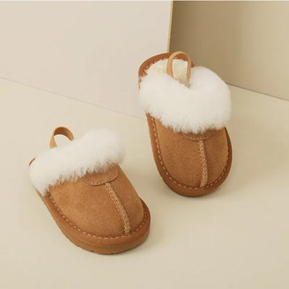 Plush pink toddler slippers with non-slip sole, perfect for warm winter indoor play.