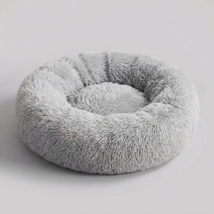 Luxurious faux fur anti-anxiety dog bed. Super soft, plush calming pet bed provides deep comfort and soothing relief.