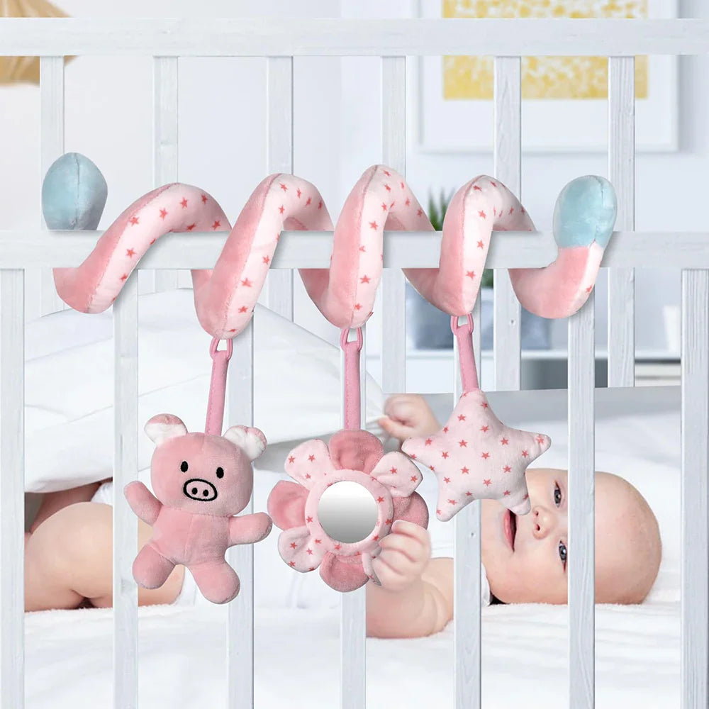Newborn safely interacting with a soft spiral crib toy, sensory and developmental play