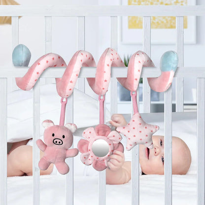 Newborn safely interacting with a soft spiral crib toy, sensory and developmental play