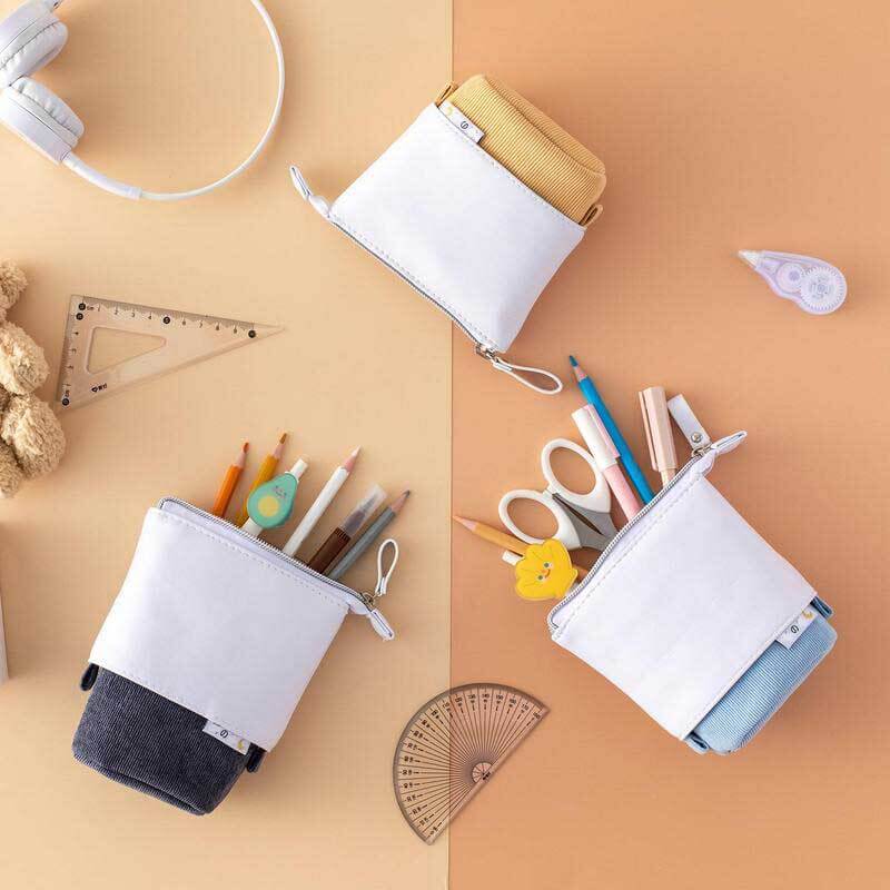 Compact pastel corduroy pencil case, converts to a stand-up holder for student desks.