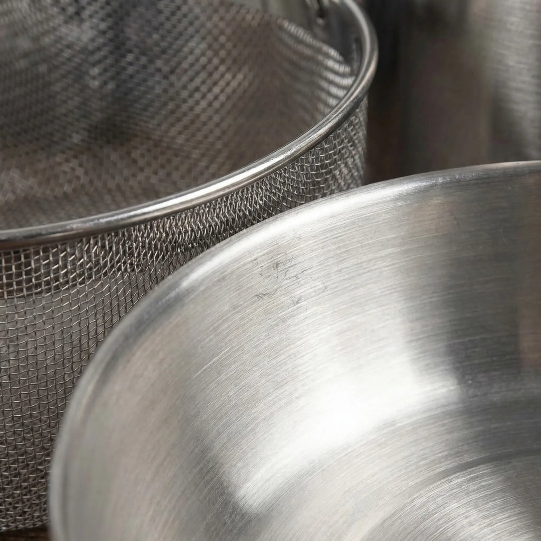 Versatile 10-piece portable outdoor cookware set. Essential stainless steel pots & pans for family camping & picnics.