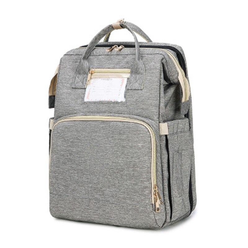 Foldable infant sleeper & diaper bag backpack; a compact changing station for busy, traveling parents.