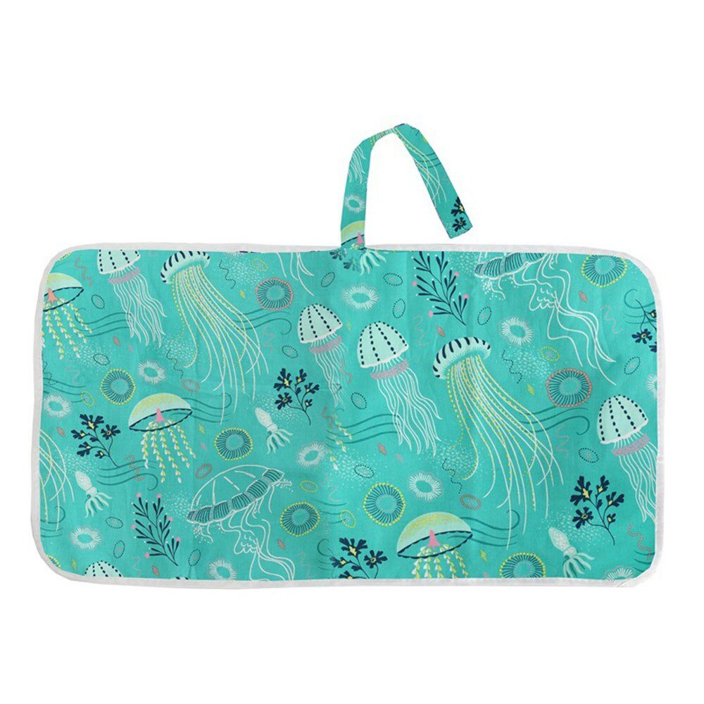 Portable baby changing pad laid out, emphasizing its convenience and clean barrier for infant hygiene.