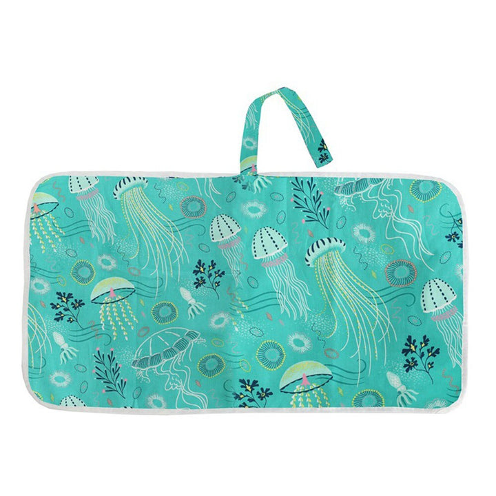 Portable baby changing pad laid out, emphasizing its convenience and clean barrier for infant hygiene.