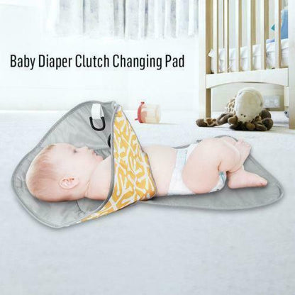 Open portable baby changing pad showing clean hands barrier and cushioned headrest for infant comfort.