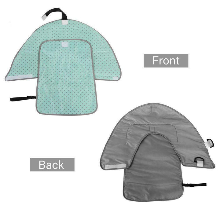 Baby on a portable changing pad, illustrating the clean hands barrier in use during a diaper change.