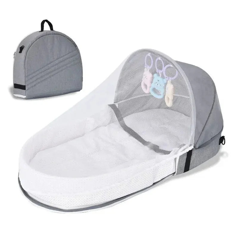 Portable newborn travel bassinet with mosquito net, demonstrating foldable feature