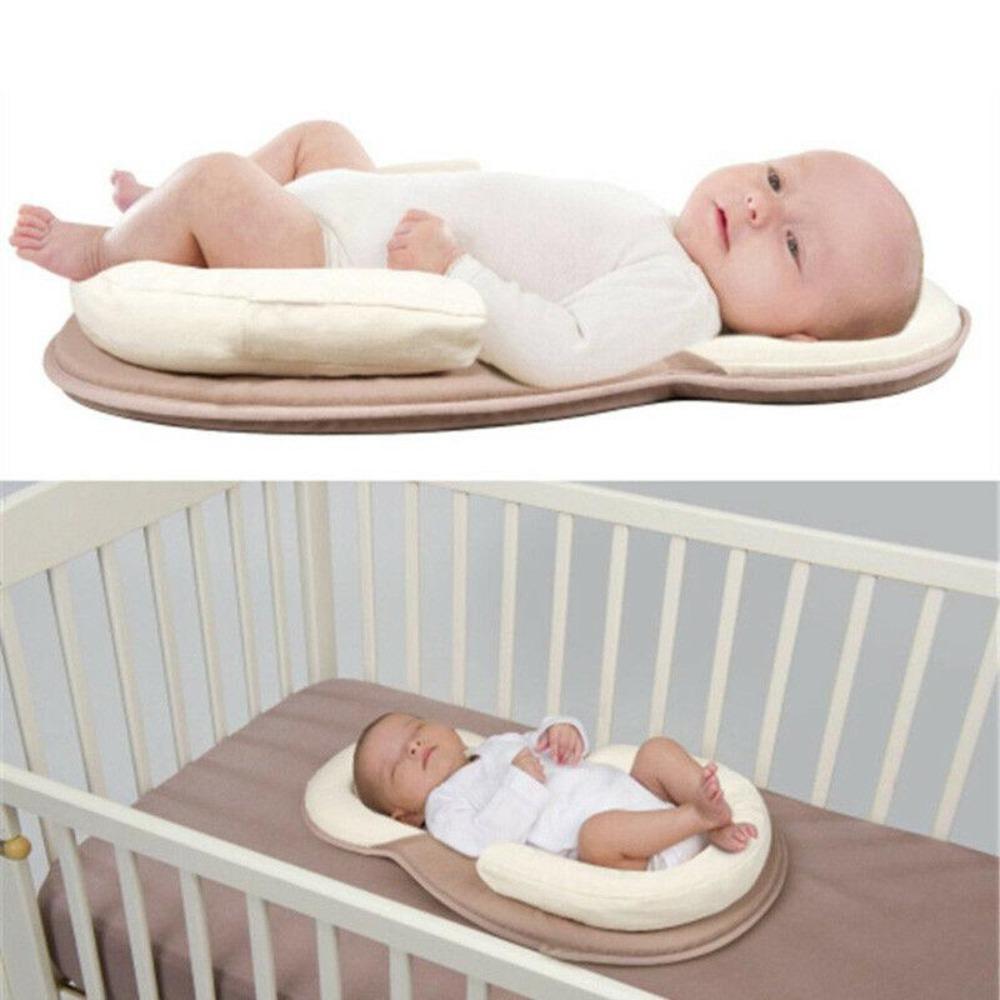 Portable baby sleep positioner and anti-roll bed for safe infant slumber and travel