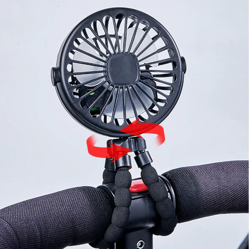 Baby on stroller, cooled by a clip-on portable USB rechargeable fan, a summer essential.