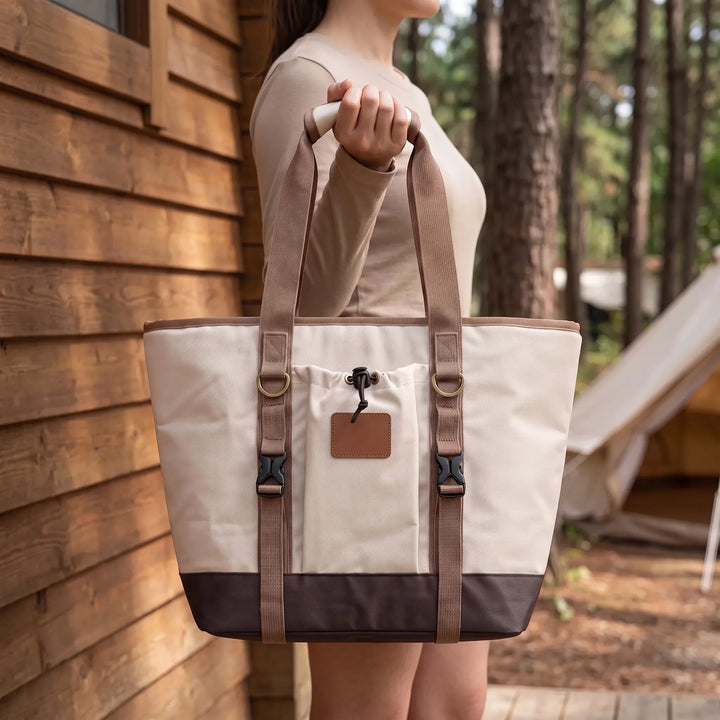 Portable insulated cooler bag for outdoor picnics, keeping food fresh and drinks cold. Ideal for travel & camping.