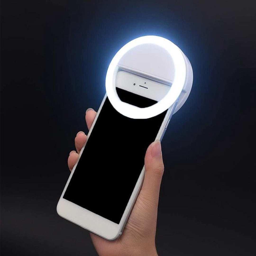 Portable LED selfie ring light for smartphones & laptops. USB rechargeable for content creation & video calls.
