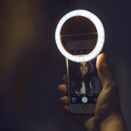 Compact, portable selfie ring light for better lighting on phones & laptops, ideal for content creation & streaming.