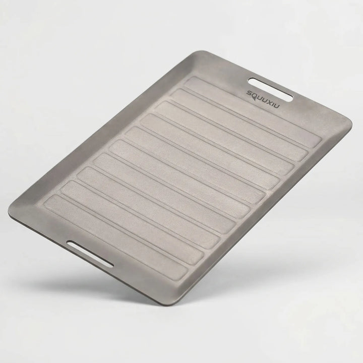 Durable ridged grill plate & tongs, essential hiking gear for solo camping, backpacking, and adventure cooking.
