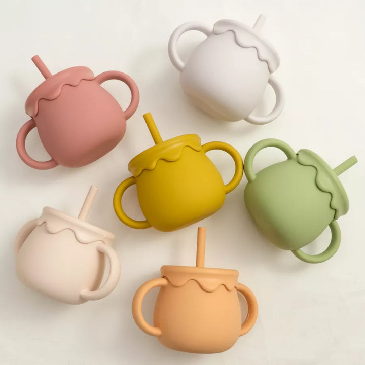 Versatile silicone baby food cup with handle, perfect for healthy on-the-go toddler snacks.