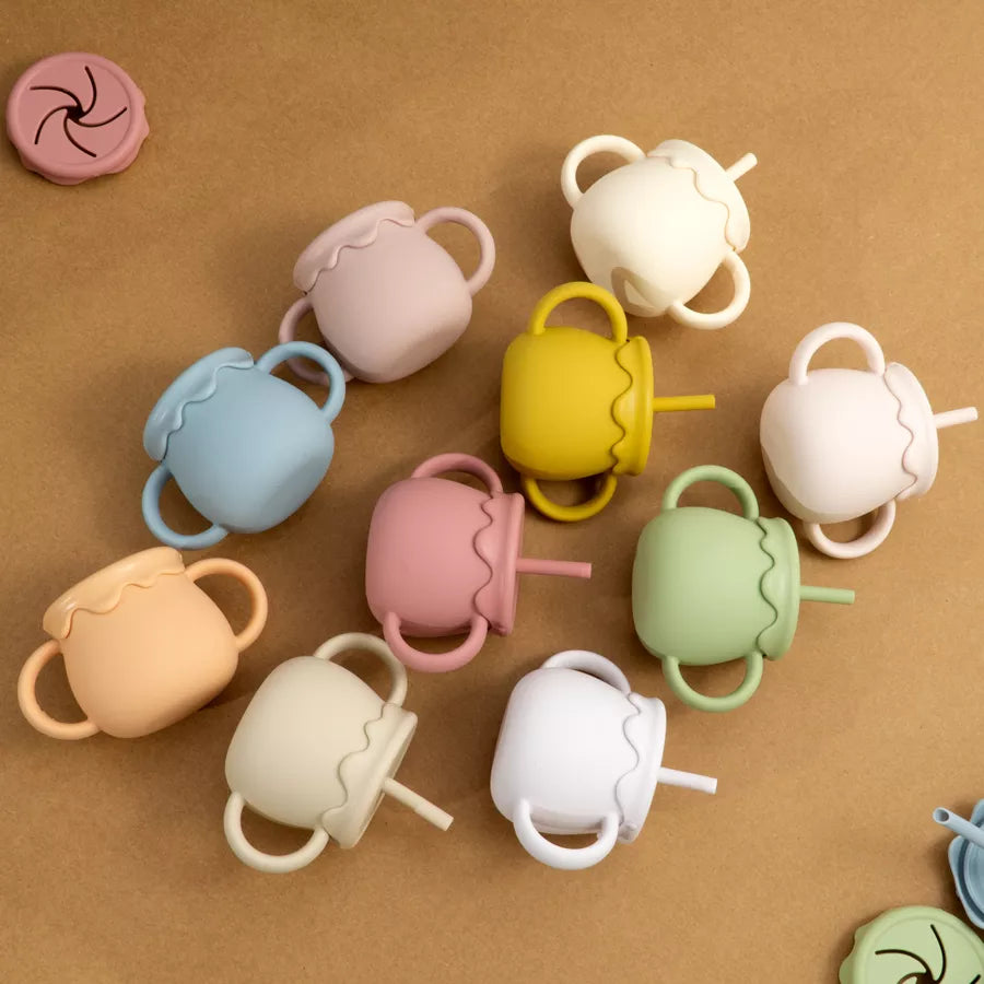 Durable silicone portable food cup with handle for mess-free baby meals & toddler snacks.