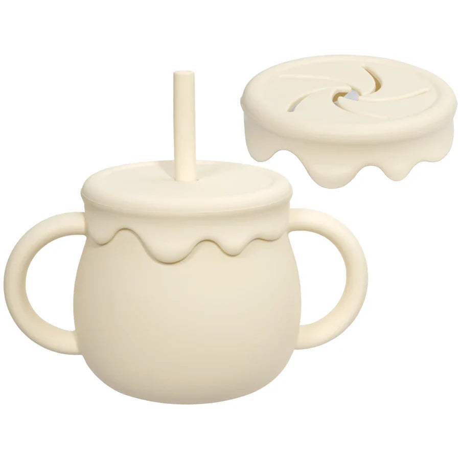 Non-spill portable silicone food cup for baby and toddler snacks, featuring an easy handle.