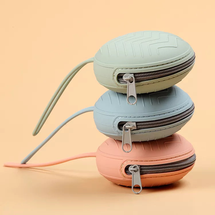 Silicone pacifier case attached to a diaper bag, showcasing its portable design for baby travel