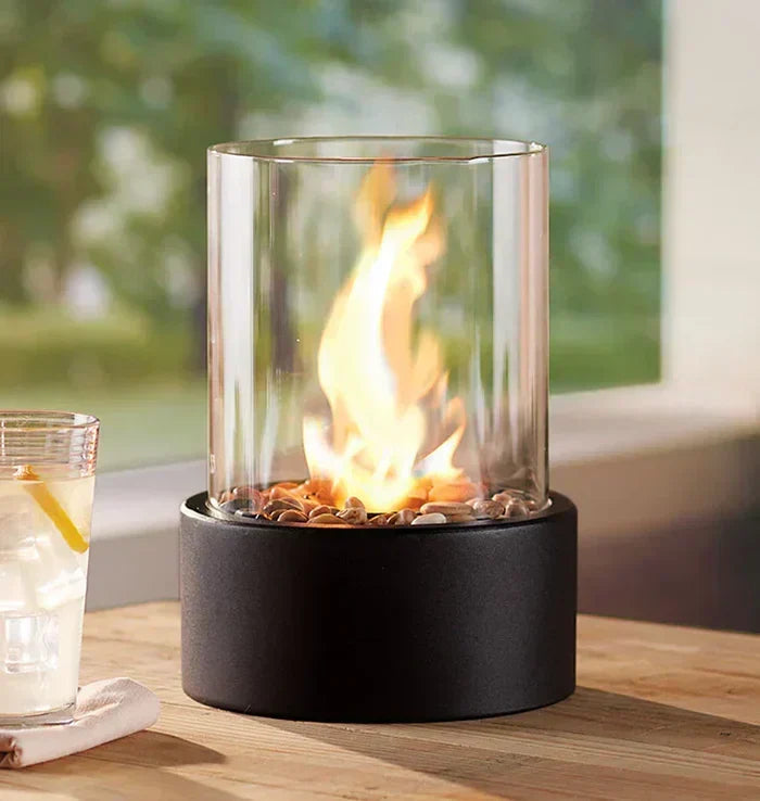 Tabletop gas fire lantern creating a cozy flame ambiance for garden decor or indoor living spaces. Portable.