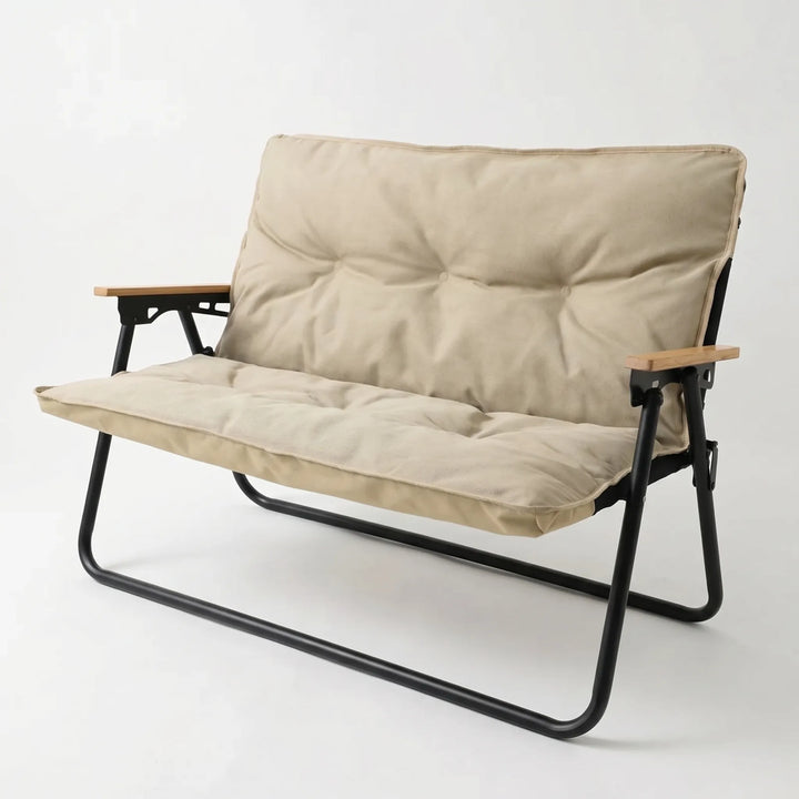 Grey portable two-person outdoor sofa, folded for easy transport, a versatile piece of camp furniture.