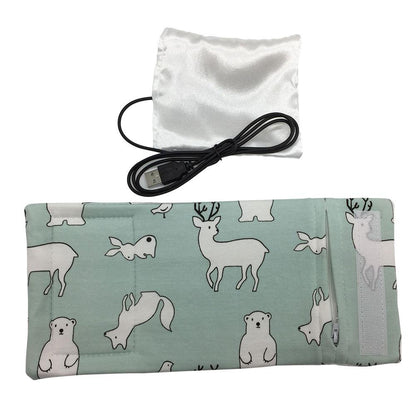 Portable USB milk warmer securely holding a baby bottle, great for travel and outings