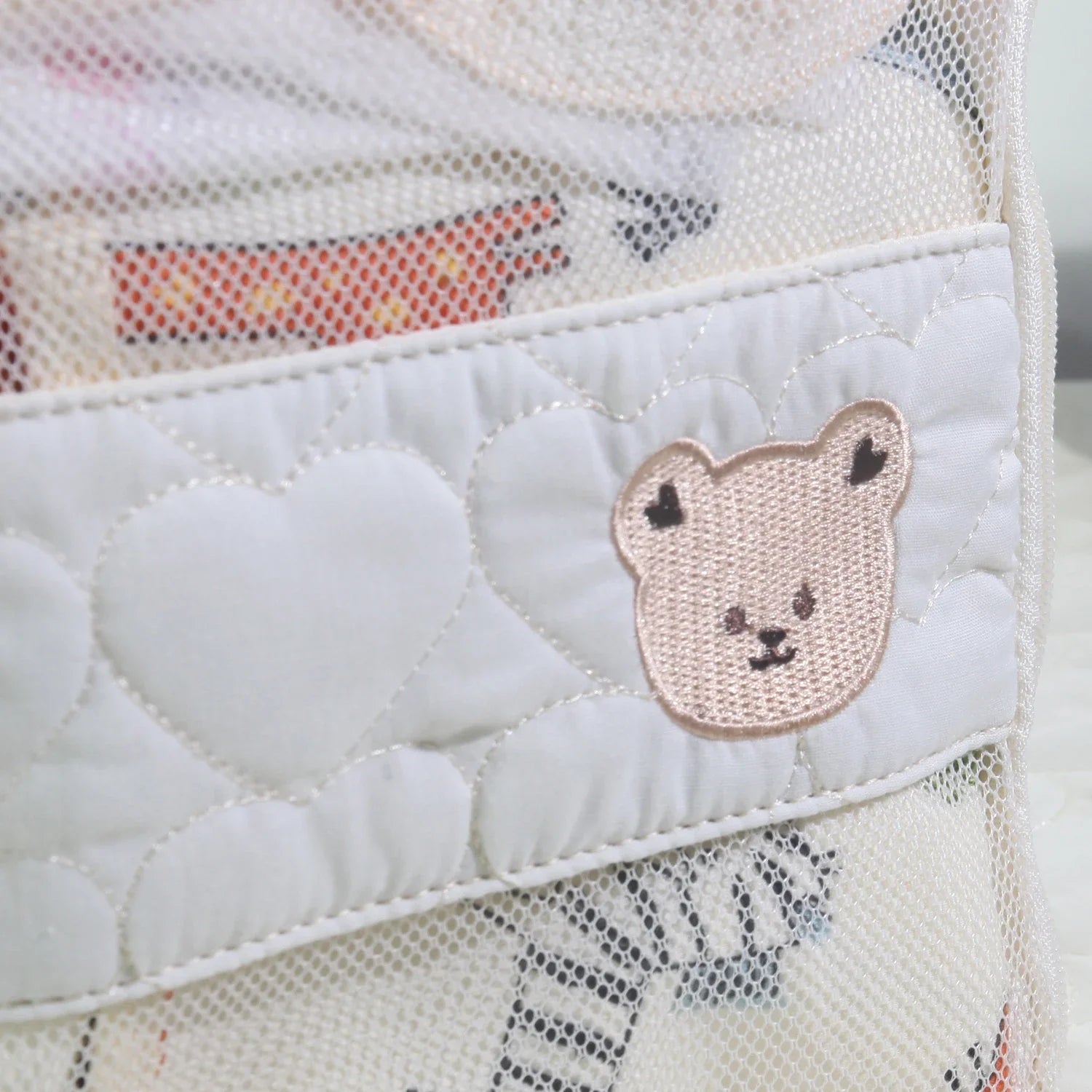 Detail of waterproof fabric on a white bear portable travel diaper bag, ideal for baby essentials