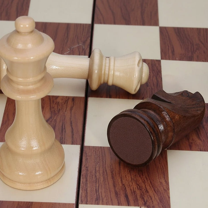Elegant folding wooden chess board with solid wood pieces, a classic strategy board game for home or travel.