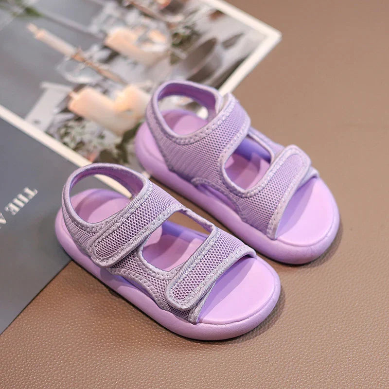 Close-up of kids' summer sandals in purple, showing breathable design and durable sole for active toddlers.