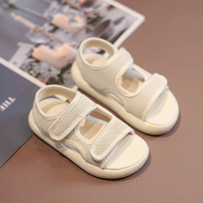 Pair of purple children's beach shoes, lightweight and breathable, designed for toddler comfort.