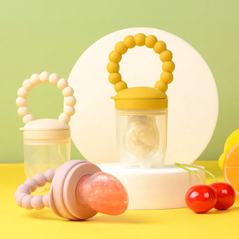 Infant holding a purple fruit feeder pacifier, making a mess-free introduction to solids
