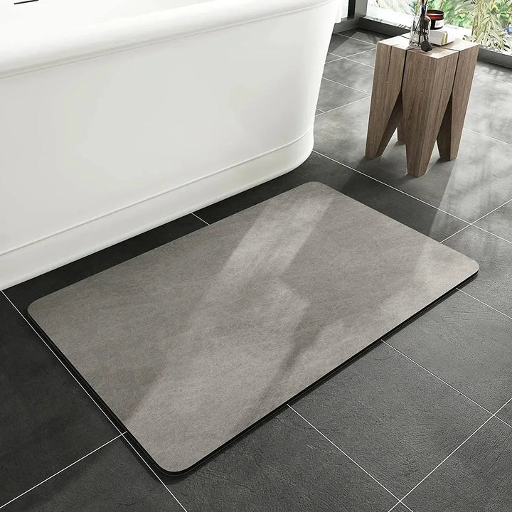 Anti-slip diatomite mat for home. Quick dry and highly absorbent, great for bathroom or kitchen decor.