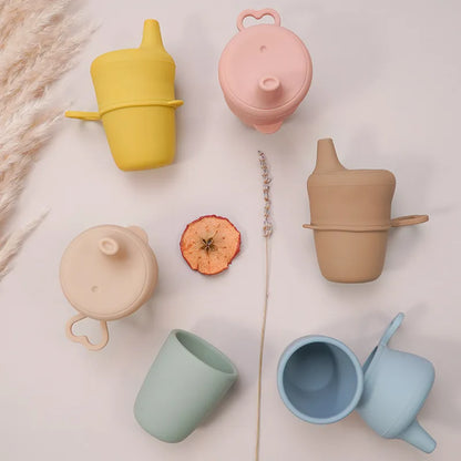 Yellow baby snack cup, soft silicone, spill proof design for active feeding