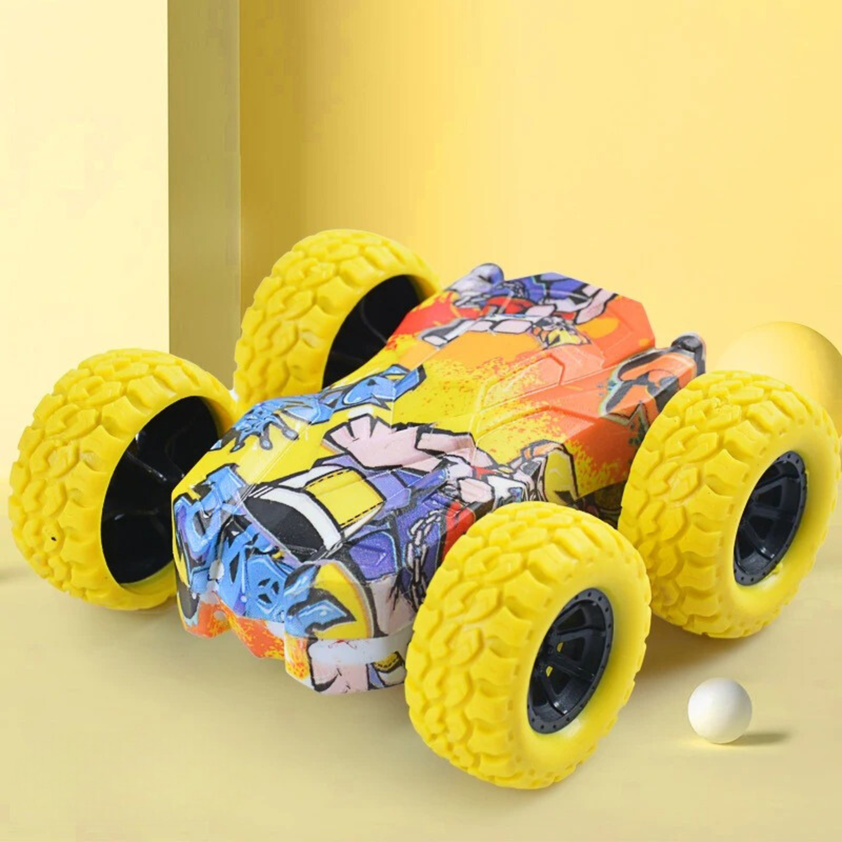 Action shot of an inertia stunt car flipping, showcasing its double-sided feature and durability