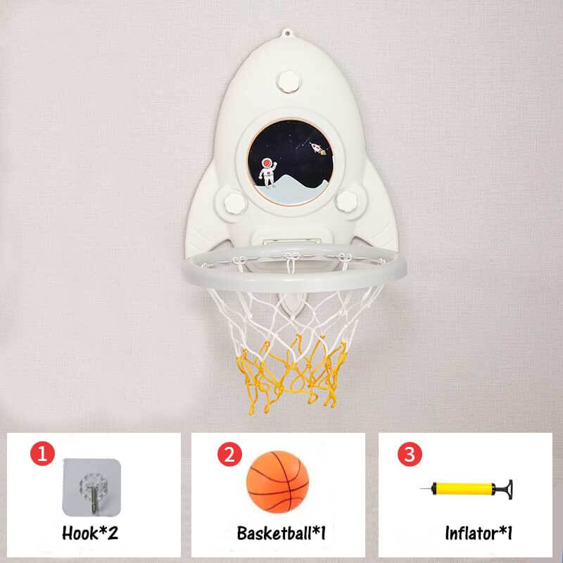 Child reaching for a wall-mounted red and blue mini basketball hoop, promoting active fun & sports skills.