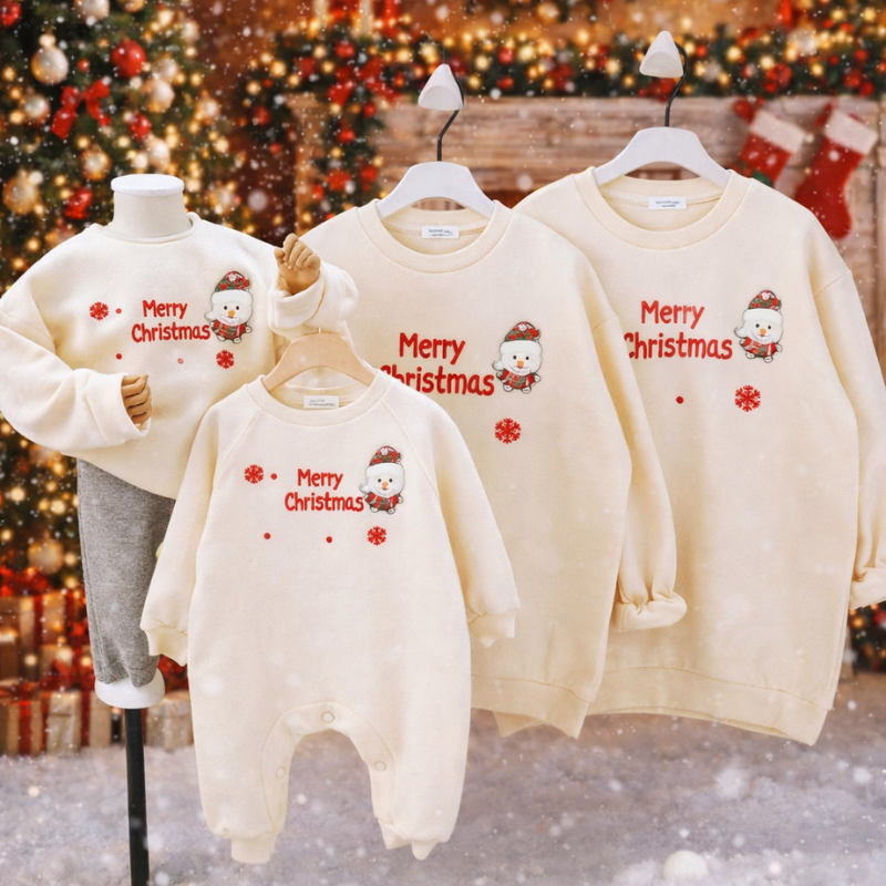 Close-up of a red baby romper with a festive Christmas tree design.